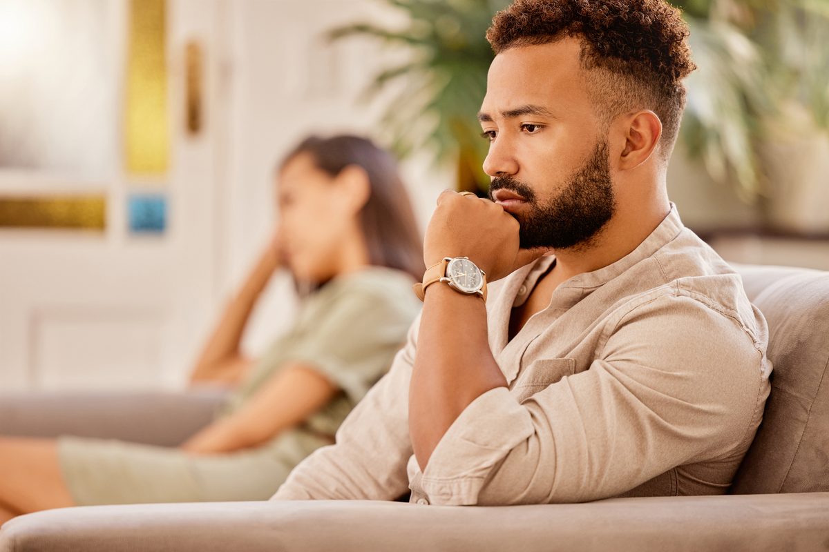 A couple sitting apart at home during a high conflict separation