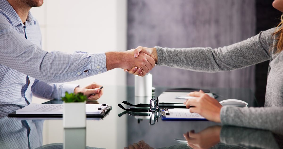 Two people shaking hands in agreement